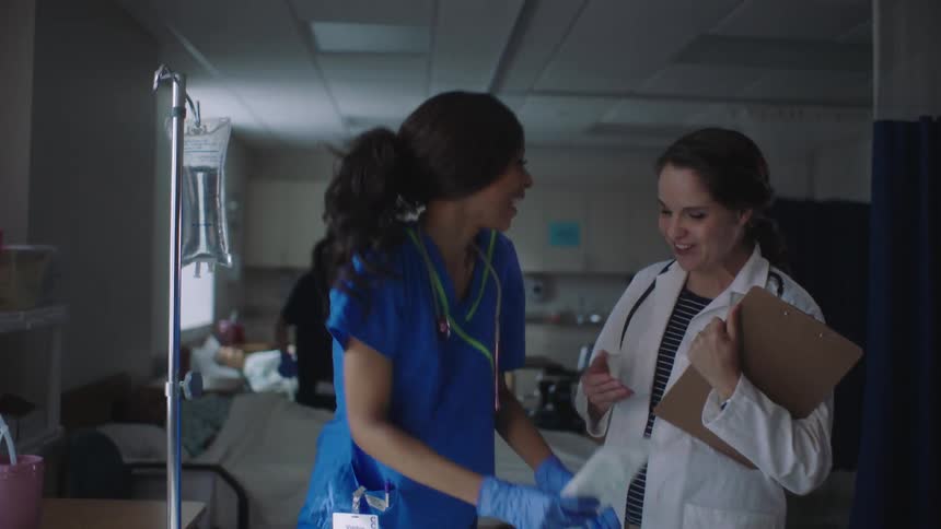 A doctor talks with a nurse in the hospital