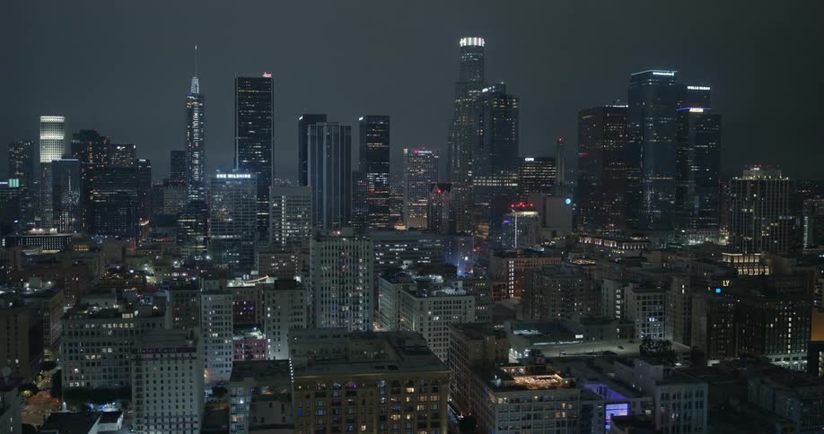 Skyscrapers loom over a metropolis at night