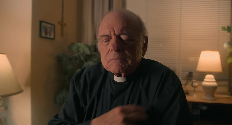 Elderly man kneels at prays before crossing himself