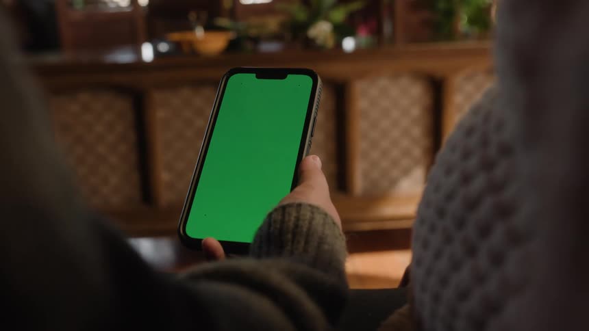 A mans hand holding a smartphone