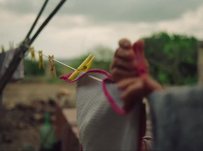 A clothesline with clothes being hung