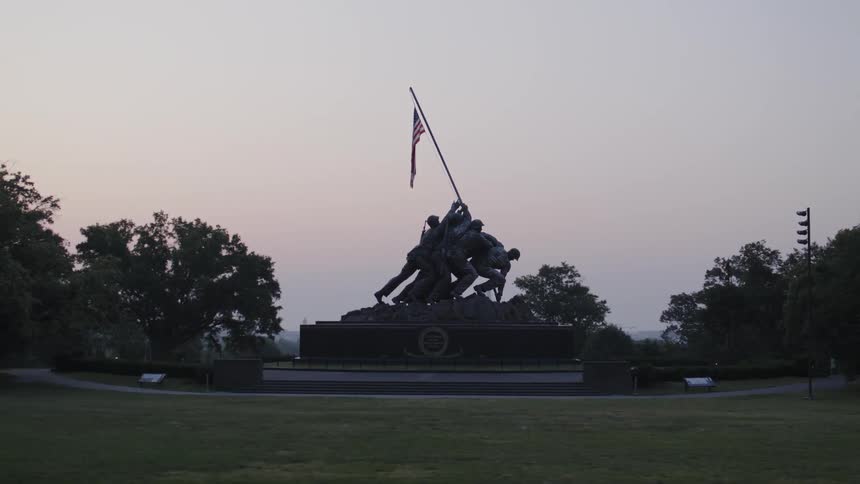 A statue depicts soldiers hoisting an american flag