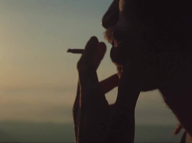 Close up view of a man smoking a cigarette