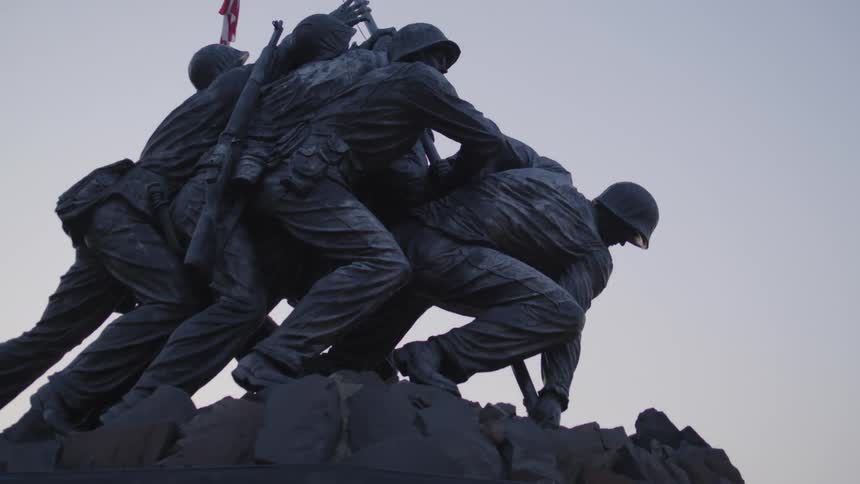 A statue depicts soldiers hoisting an american flag