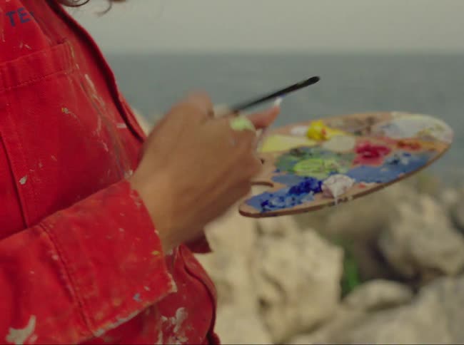 Woman painting a picture outdoors
