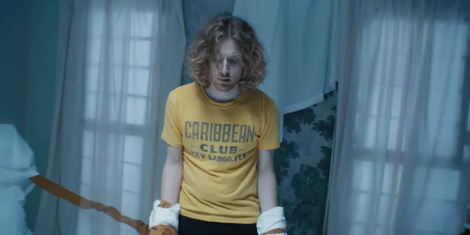 Confused man with boxing gloves in a ring indoors