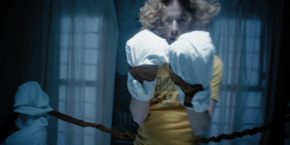 Man with sheets wrapped on his fists imitating box gloves spars with the cameras pointofview