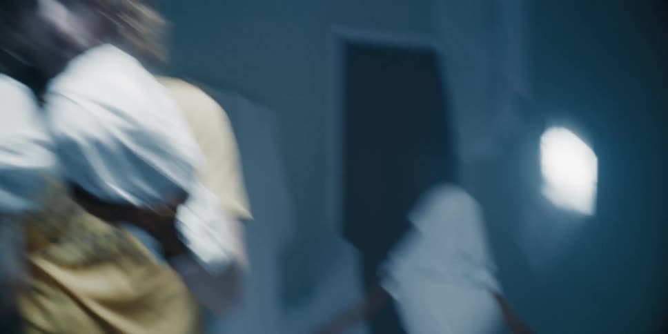 A man is boxing with sheets for gloves