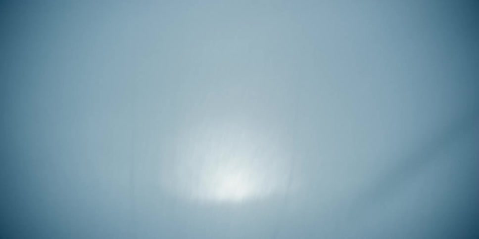 A bed sheet blows in the wind