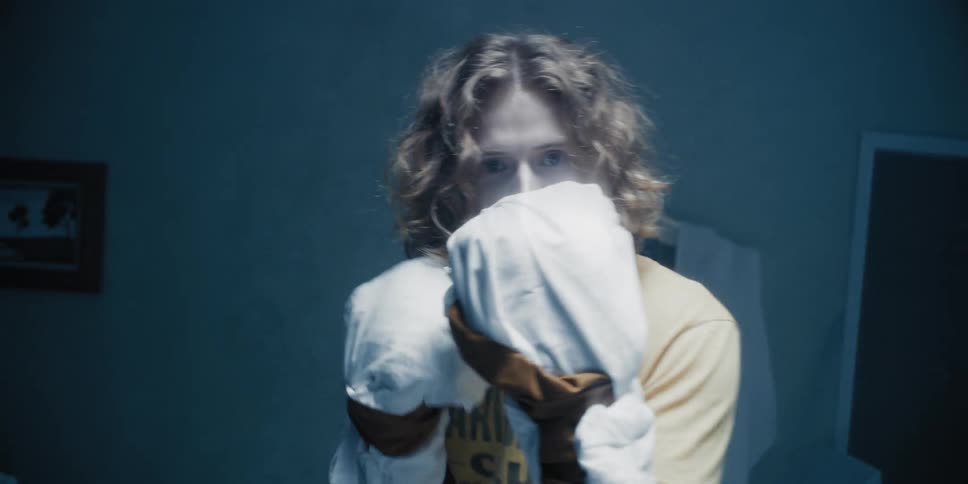 Man wearing white gloves punching at something aggressively