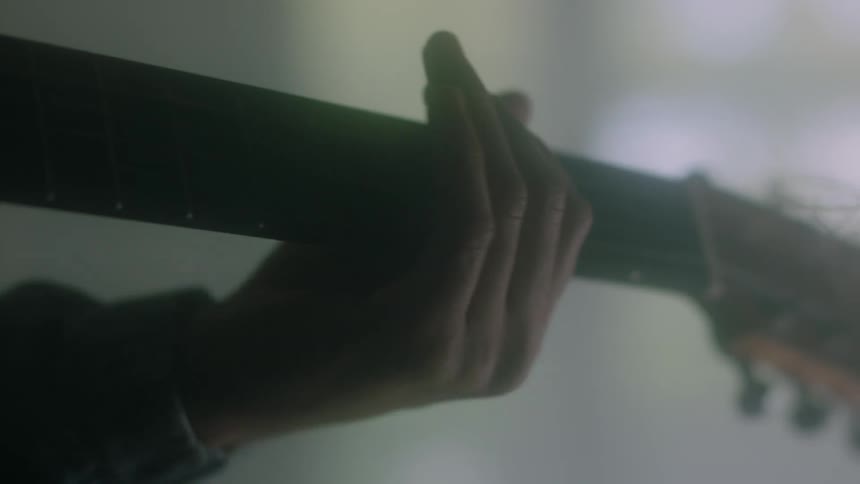 A man plays the guitar