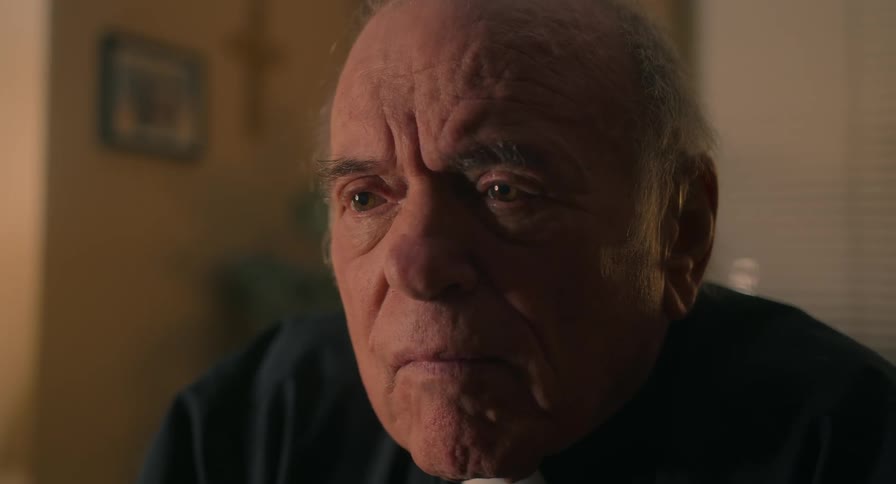 A pastor speaks to someone in an office