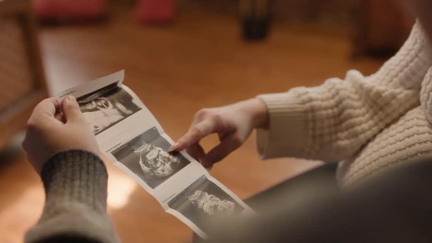 A couple looking at a sonogram of their coming baby