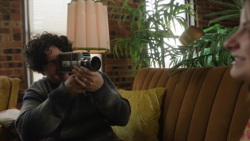 A man is recording a woman
