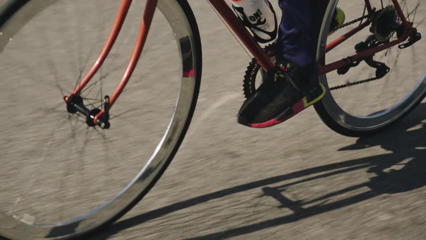 Black man riding a bike outdoors on the road