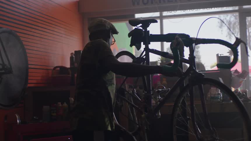 A man is working on a bike in the shop