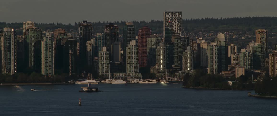 Luxury yacht marina with city on horizon