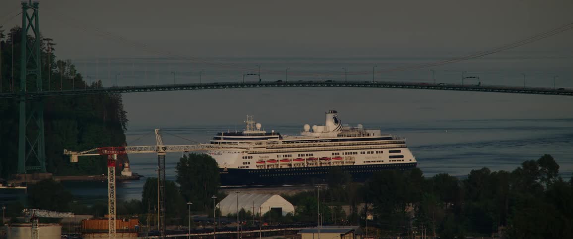 A cruise ship crosses under the bridge