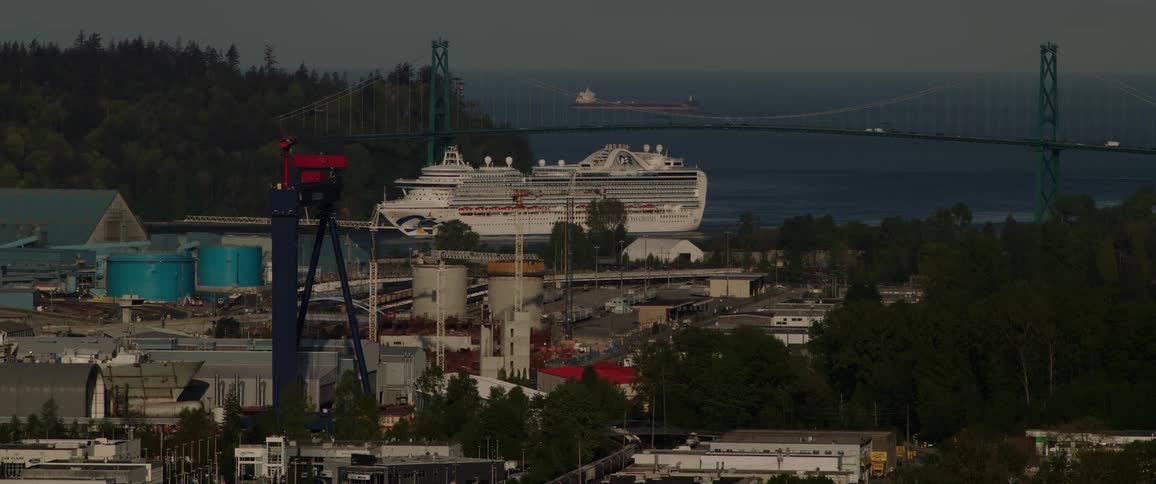 A cruise ship travels under the bridge