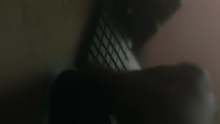 Close up of a person strumming a guitar and picking the strings
