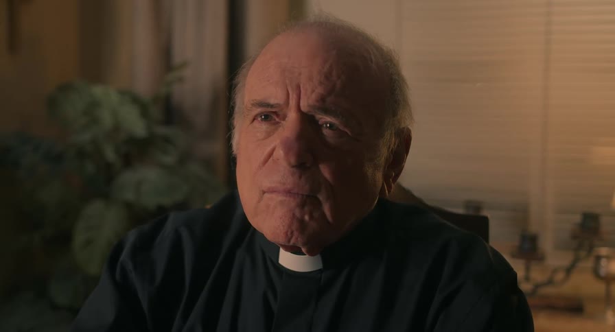 A priest sits in an office