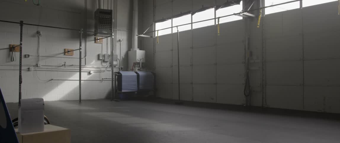 A hall is empty with light coming in front the window