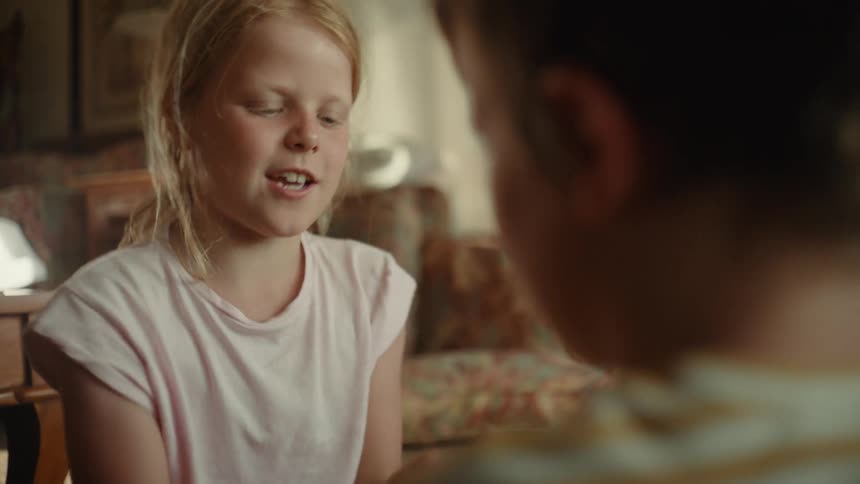 Two children playing rockpaperscissors on the floor