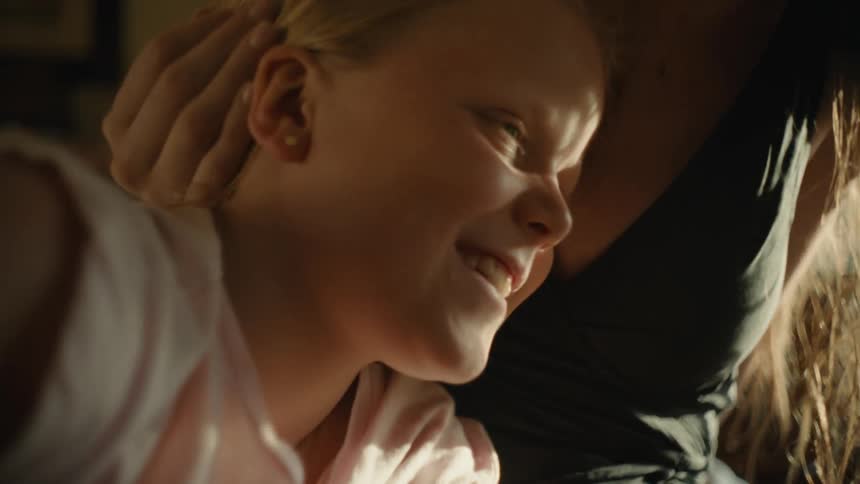 A mother brushes her daughters hair