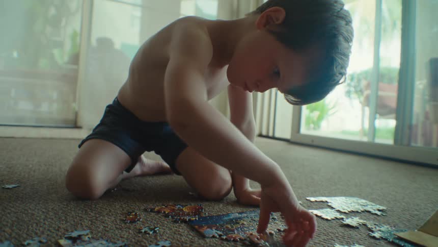 A boy is putting together a puzzle
