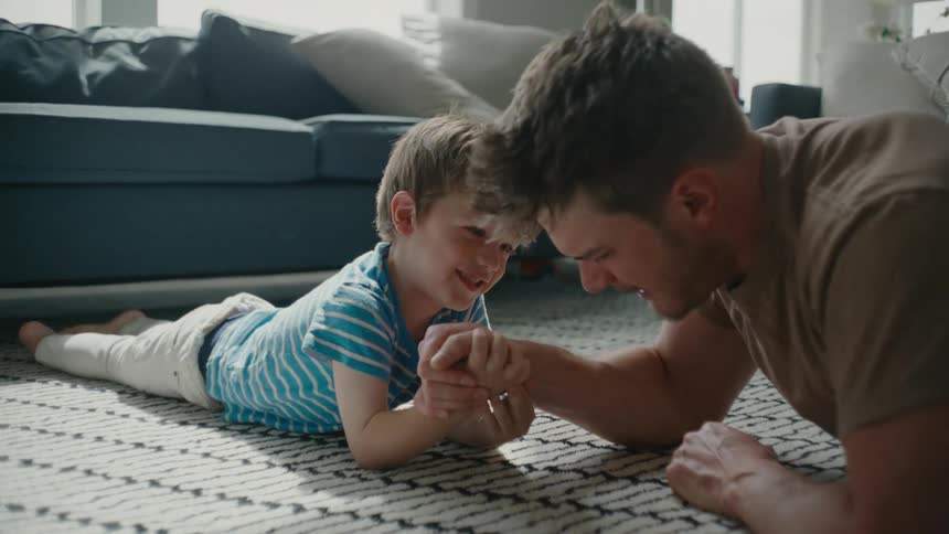 A father and son are arm wrestling