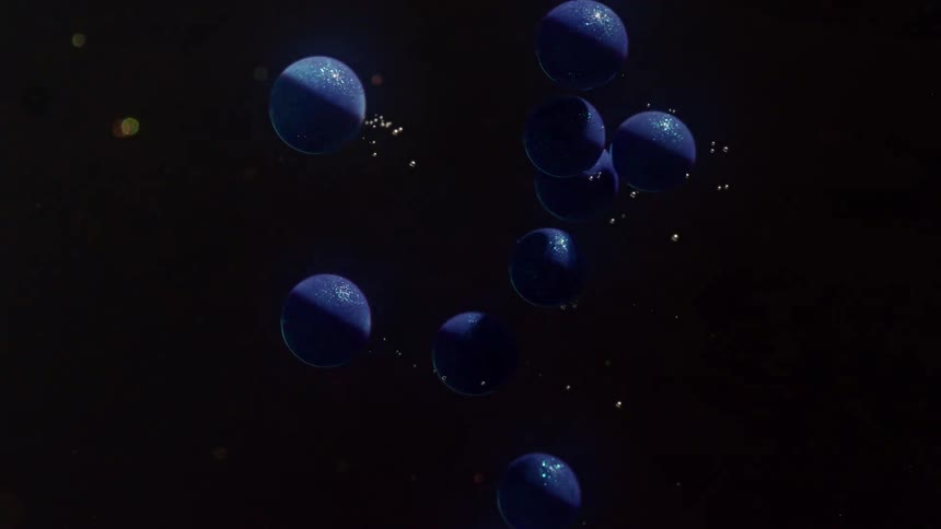 Blue balls move upwards while a strobe light shines on them