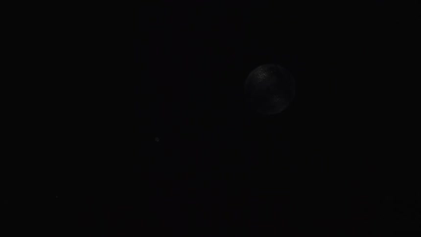 Light brightens sphere floating through light spotted darkness