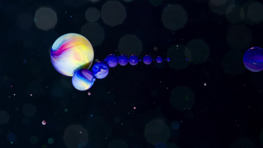 An animated video shows a large planet pushing a line of small blue planets out of alignment