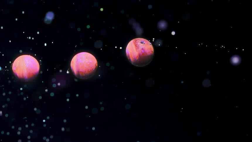 Bubbles of colored liquid passing through dark liquid