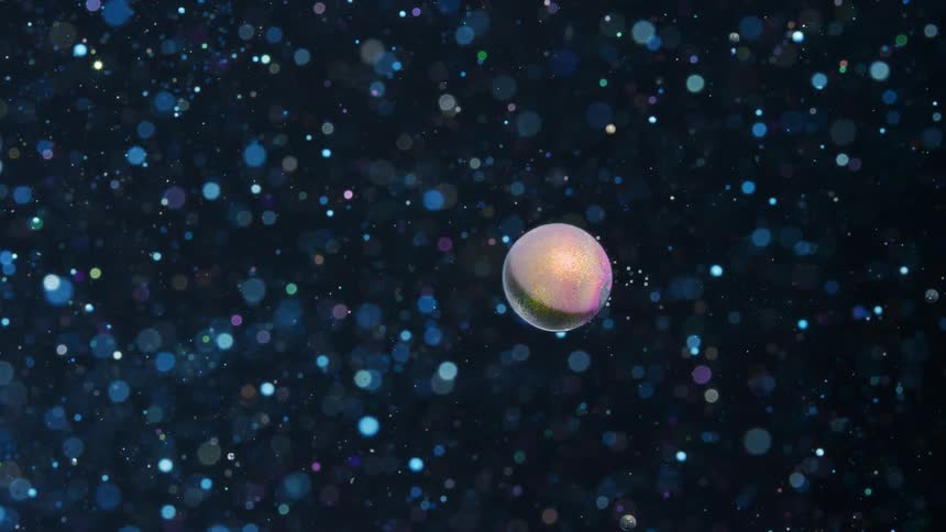 Colorful spheres floating moving forward with smaller spheres all around it