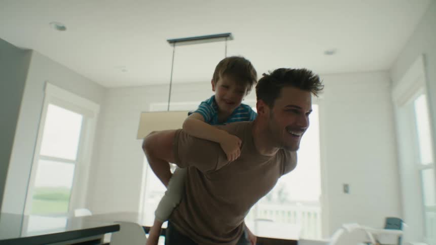Father Shares Laughter With His Son on a Playful Piggyback Ride
