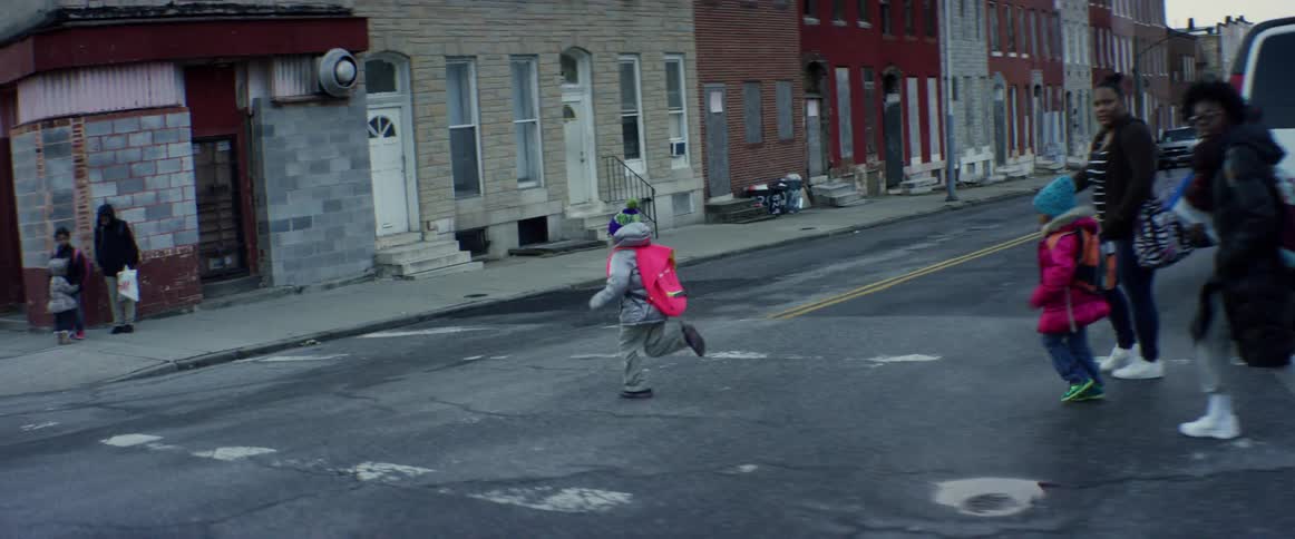 A child running cross a city street