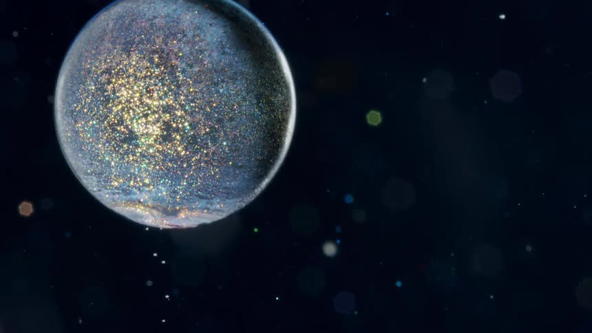 Abstract sparkly sphere moving slowly upwards with a black sky background