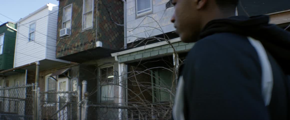 Man walks in front of houses
