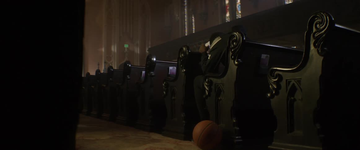 A single person is sitting in a church