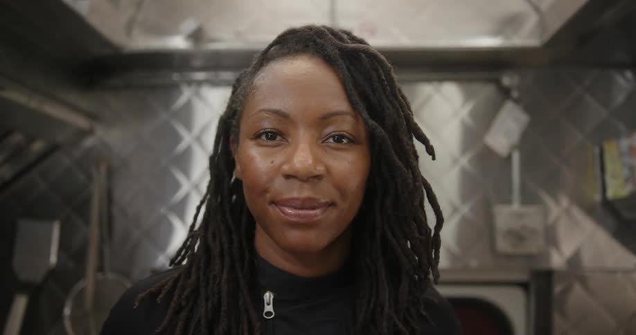 Portrait of a woman smiling in a kitchen