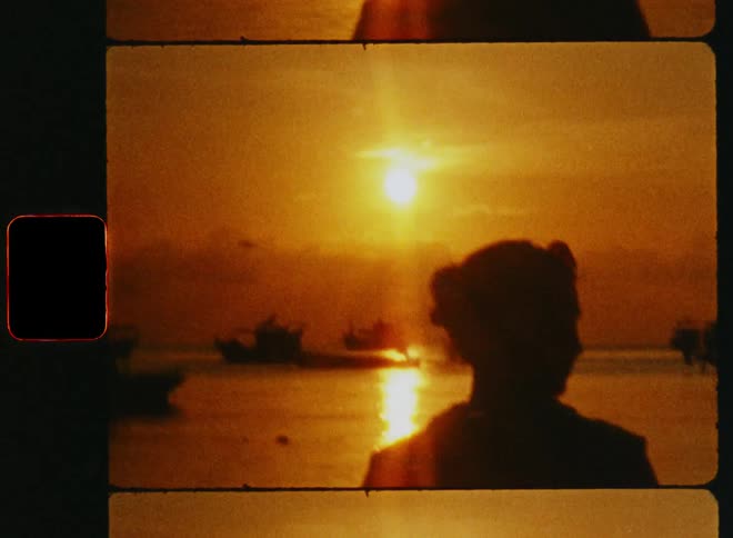 The view is of a woman that is on the beach and looking at the scenery