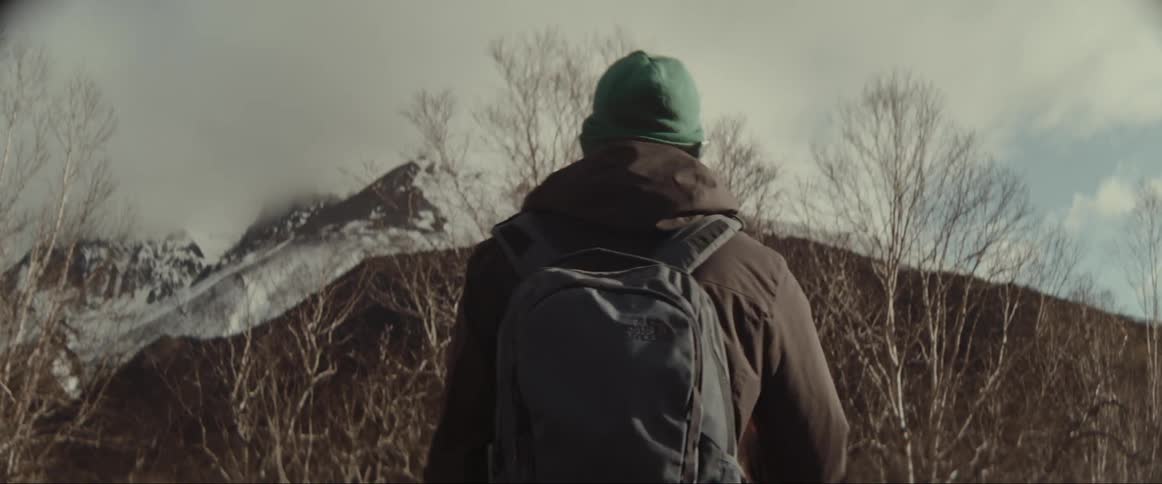 Man and woman hiking towards a mountain