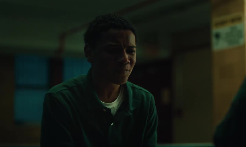 The sad teen dressed in a dark blue shirt engaged in a conversation with a weeping individual their interaction reflecting a somber and emotional moment