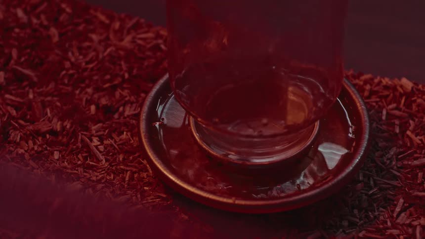 Lidded upside down jar sits in saucer among shavings