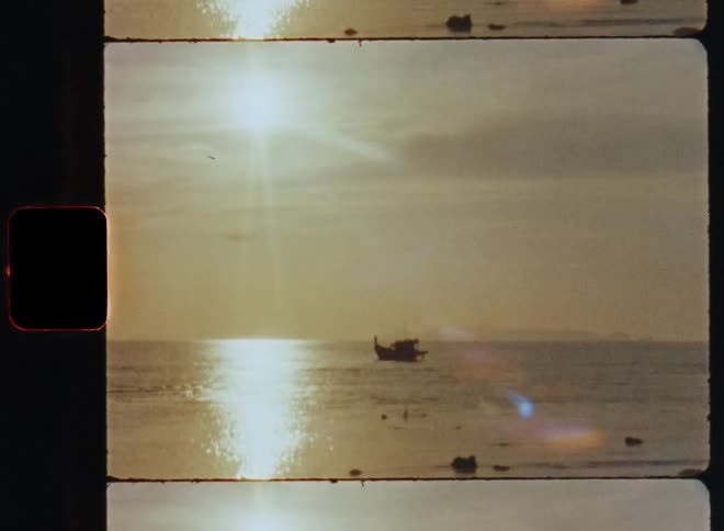 A boat sitting in the middle of the ocean during a hot sunny day