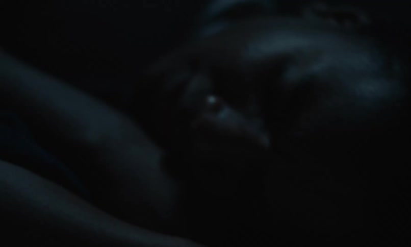 A man moves around in bed as he sleeps