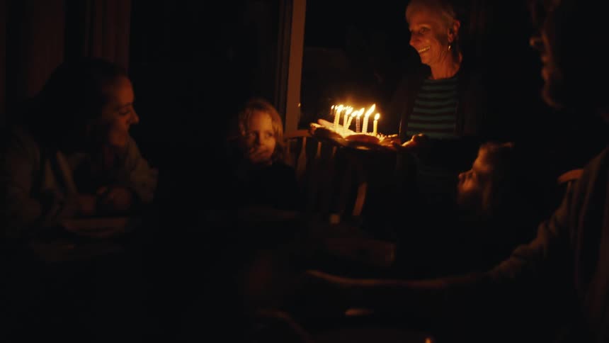 A plate of doughnuts with candles is presented at a birthday party