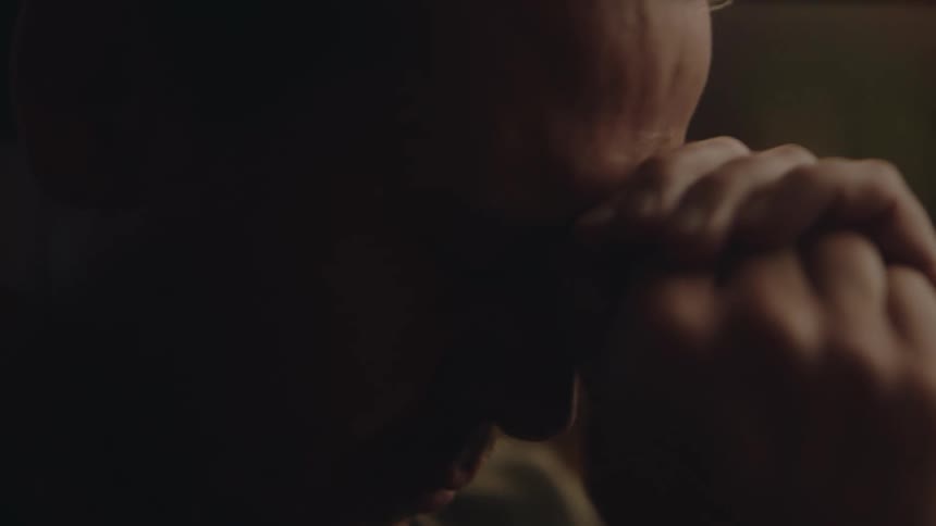Close up view of a man drinking a beer