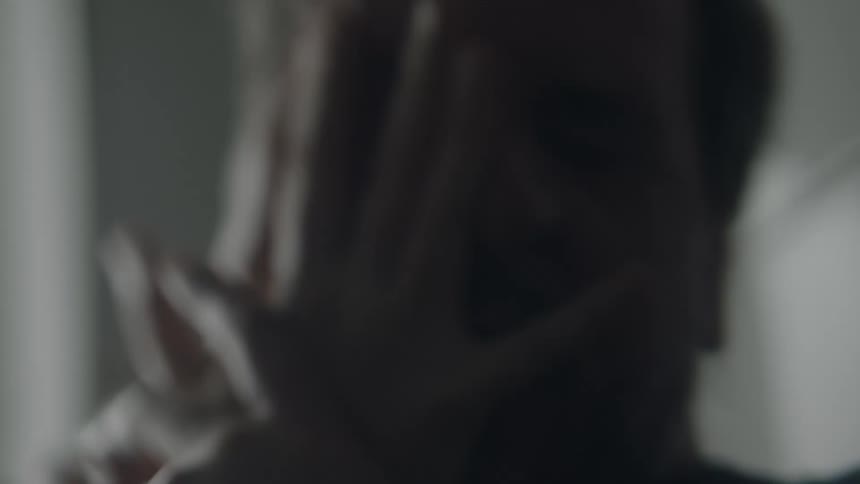 Close up of a mans face as it is smashed with a females hands as she iscombative
